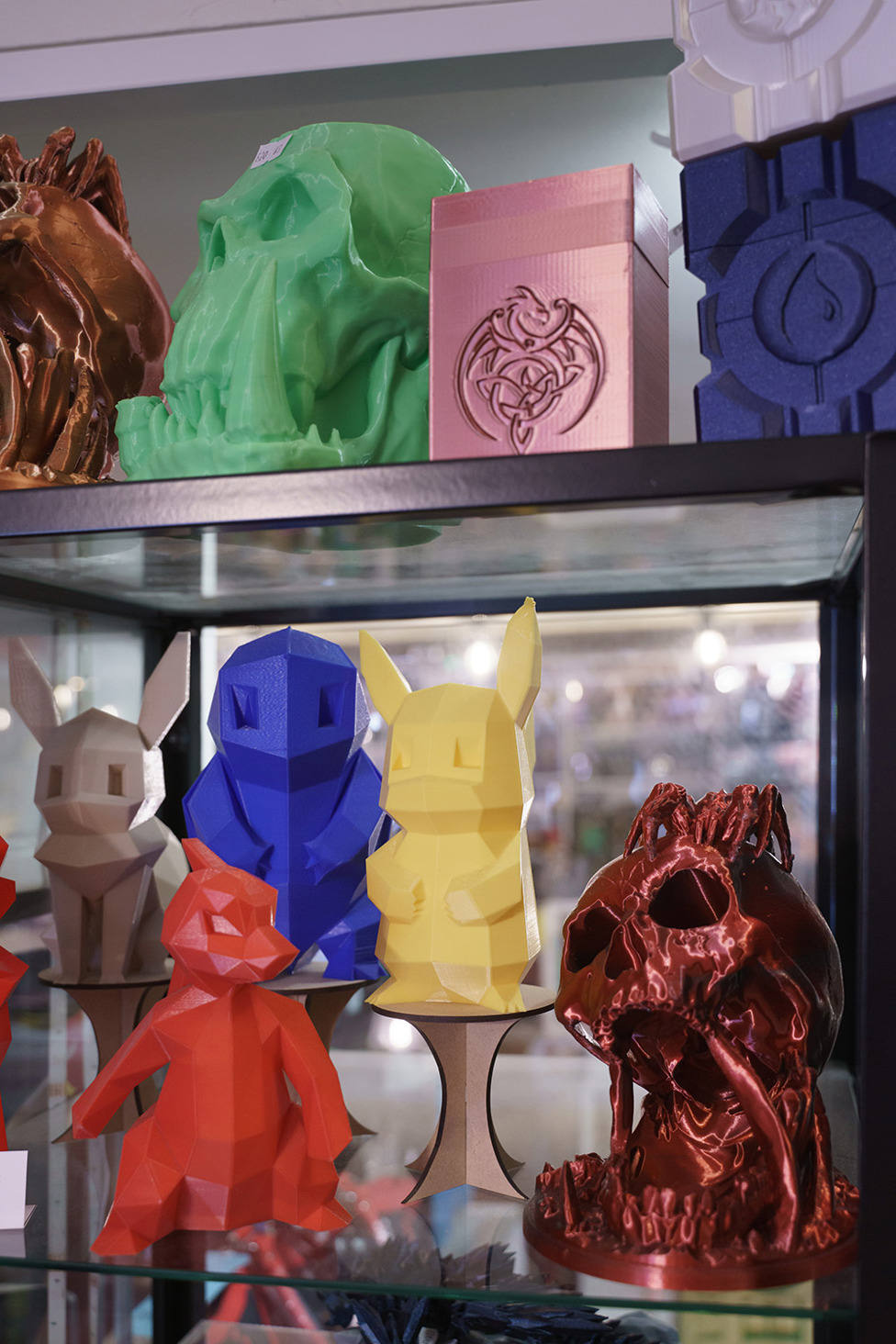 Colourful collectable figures arranged inside a display cabinet